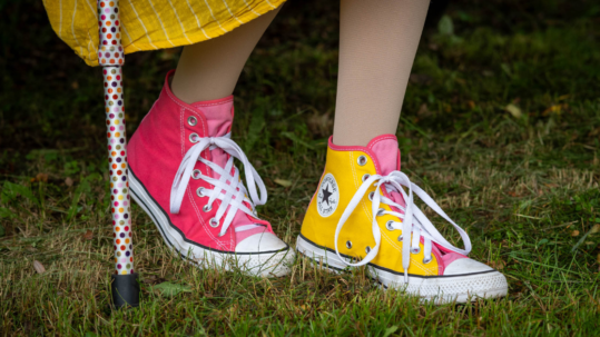 Yellow and Pink Multicolor converse with the hem of a yellow dress and a prominent single point multicolor polka dot cane